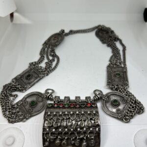 Silver necklace with red and green stones, chains and amulet box
